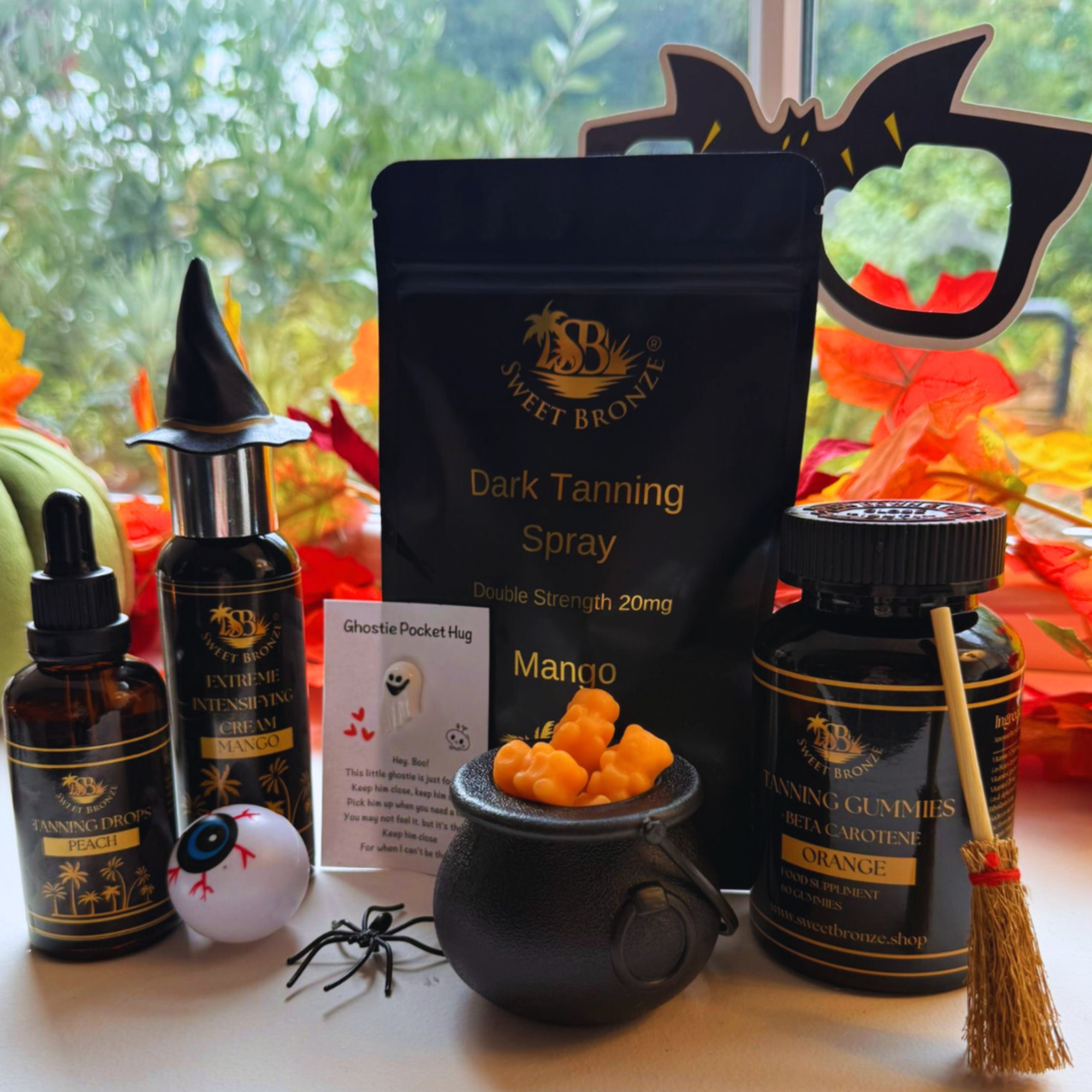 Collection of Halloween-themed products including tanning spray, gummies, and decorative items on a table.