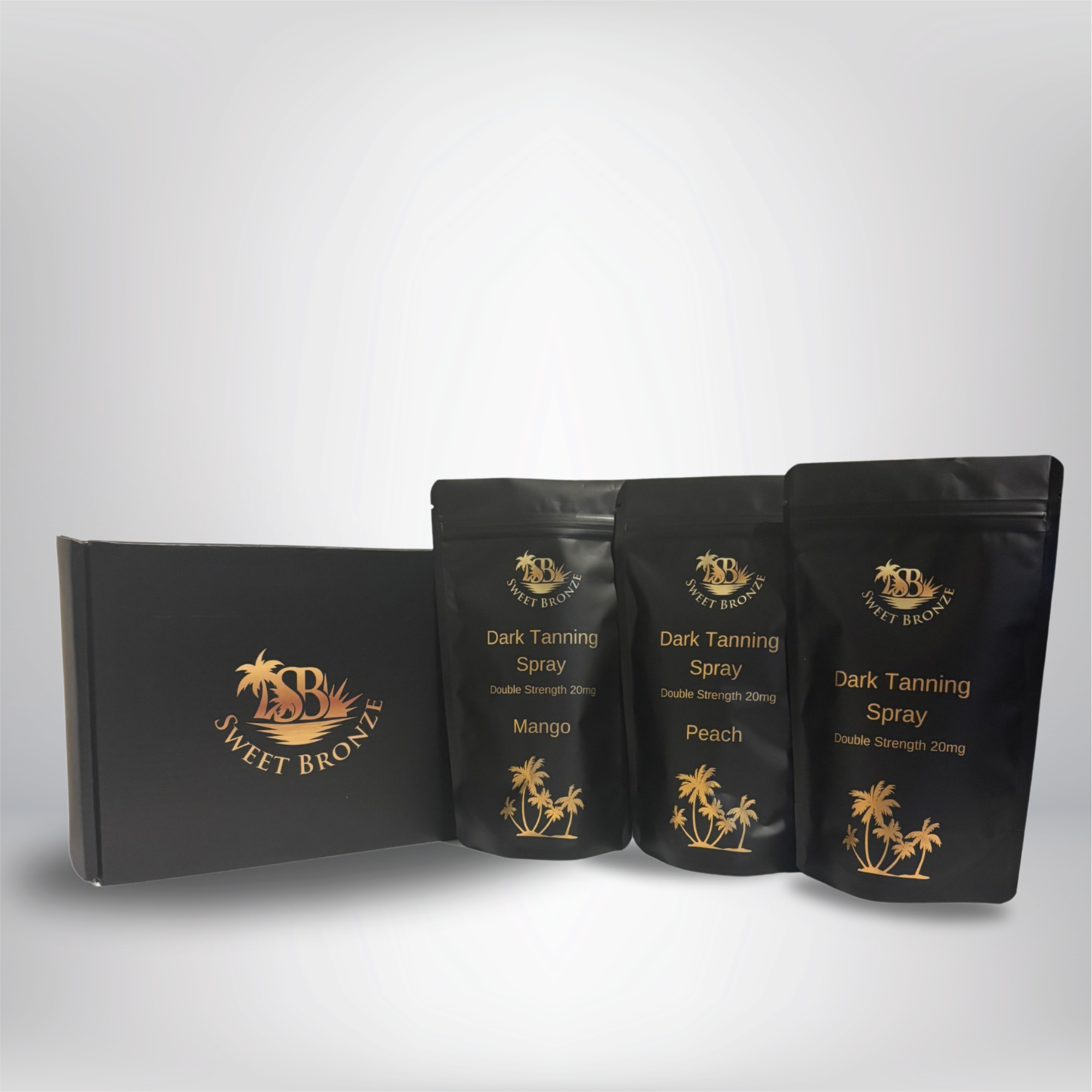 Three packets of Dark Tanning Spray Enhancer by Sweet Bronx, with flavors Mango, Peach, and a generic scent, displayed in front of a black box with the Sweet Bronx logo.